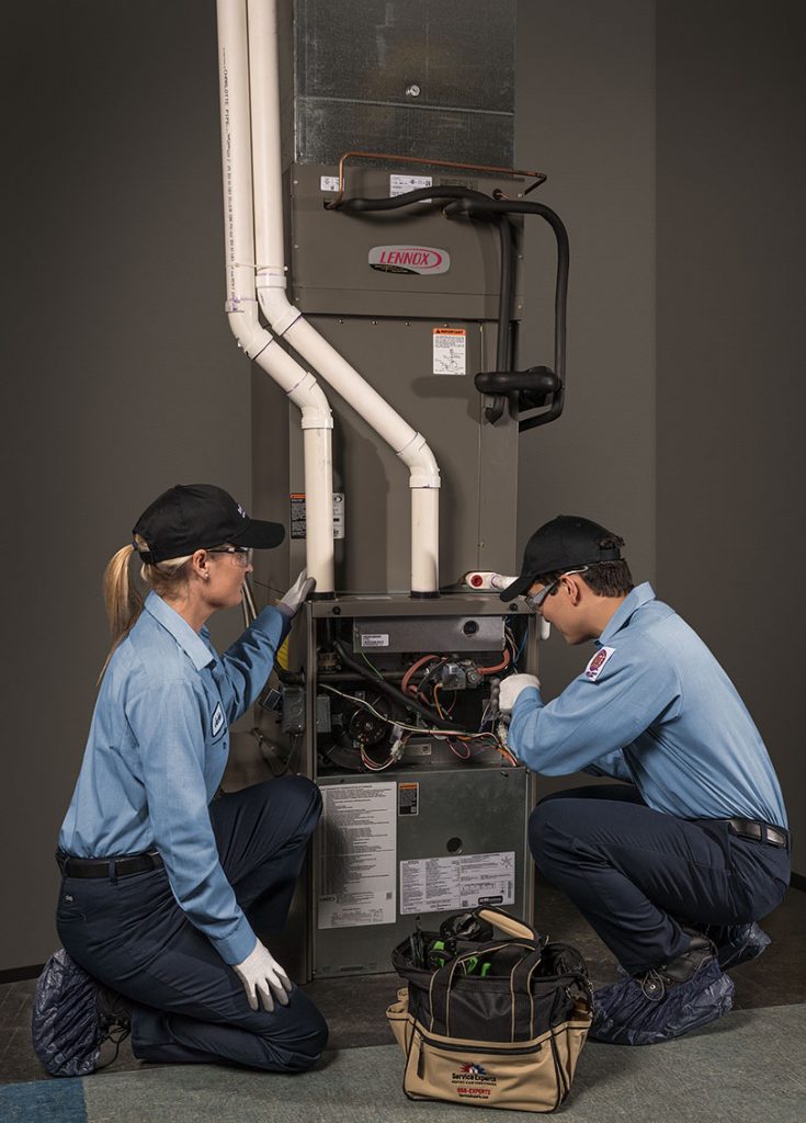 Technicians working on heater
